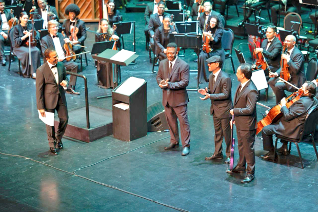 <p>The Bahrain Philharmonic Orchestra performed a tribute concert to one of Bahrain&rsquo;s most popular musical artists, the late Ali Bahar, at the Bahrain National Theatre last night. Conducted by Bahraini maestro Dr Mubarak Najem, the concert featured three members from Mr Bahar&rsquo;s the Brothers Band (Furqat Al Ekhwa) and a number of talented Bahraini singers.</p>
<p>A larger-than-life on-stage hologram of Mr Bahar, who died in 2011, sang the concert&rsquo;s final two songs, and his likeness even gave a speech an artificial intelligence (AI)-generated voice. The 1,001-seat hall was completely sold out last night.</p>
<p>Due to the overwhelming response, a second show is set to take place tomorrow night.</p>
<p>Above, Dr Najem with the three members from the band.&nbsp;</p>